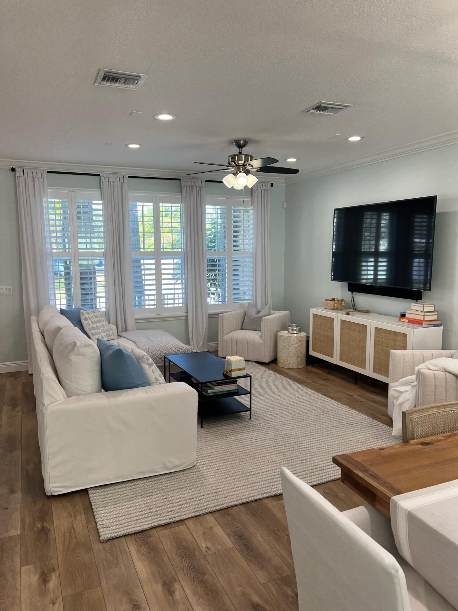1322 Turnbridge Drive Jupiter, FL 33458 - Photo 4 of 19 a living room with furniture and a flat screen tv