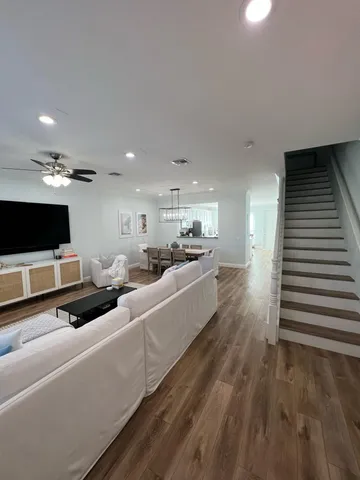 a large white kitchen with a large counter top and stainless steel appliances