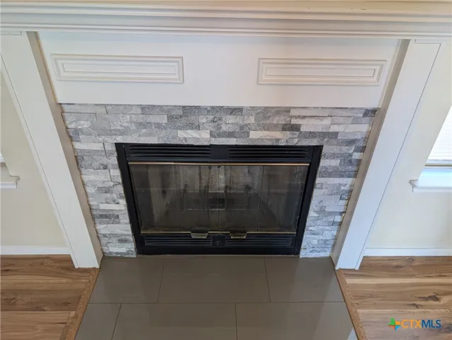 a living room with a fireplace and a rug