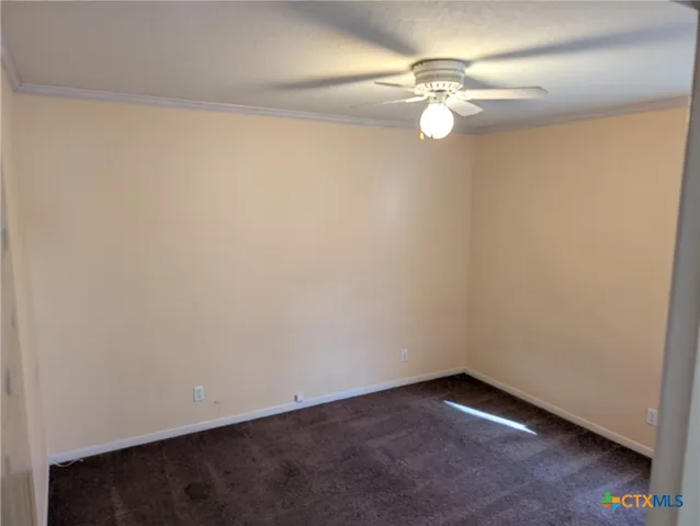 a kitchen with granite countertop a stove microwave and refrigerator