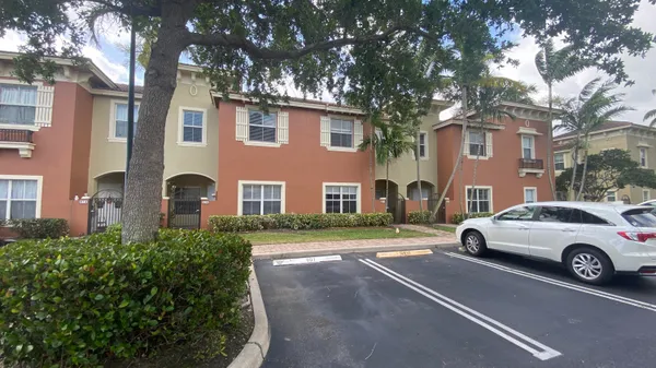 a front view of a house with parking space