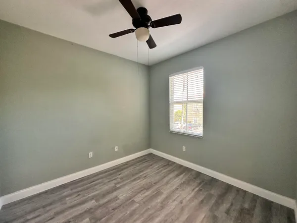 a view of walk in closet with wooden floor