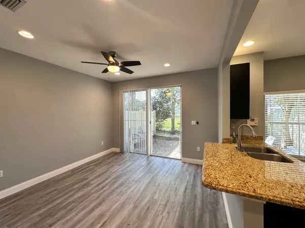 a view of a kitchen with a sink and a refrigerator