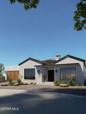 a front view of a house with a garden and parking