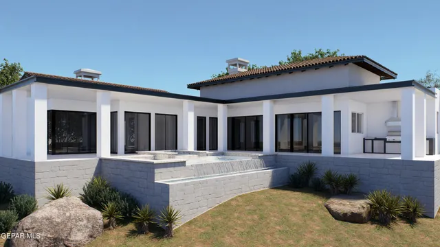 a view of a house with potted plants and a yard