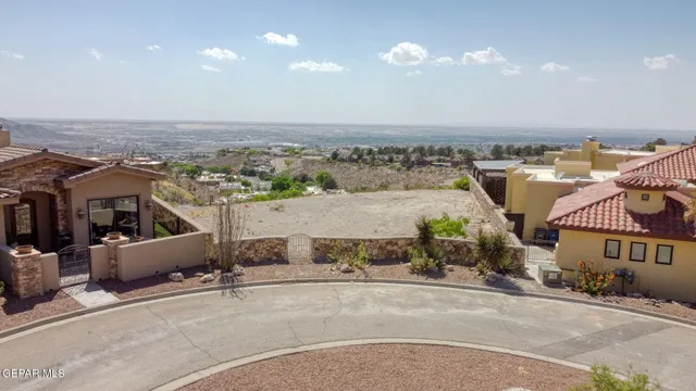 an aerial view of a house with a yard and balcony