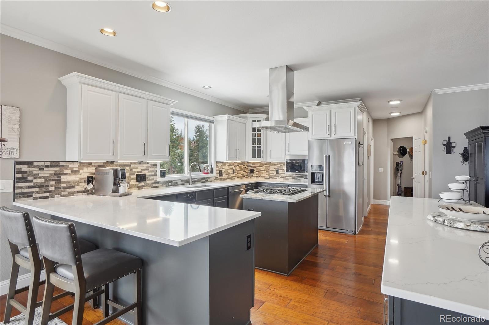 13084 Deer Ridge Way Larkspur, CO 80118 - Photo 12 of 48 a kitchen with stainless steel appliances granite countertop a sink stove and refrigerator