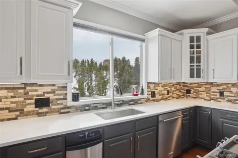 a kitchen with a sink and a window