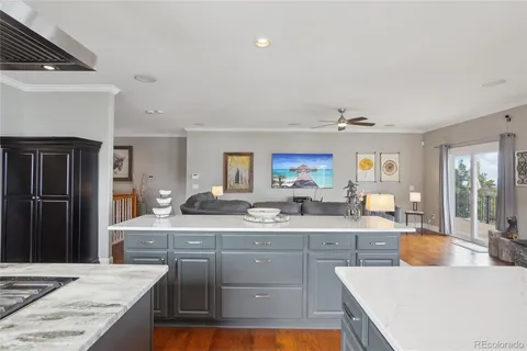 a large kitchen with kitchen island a sink stainless steel appliances and cabinets