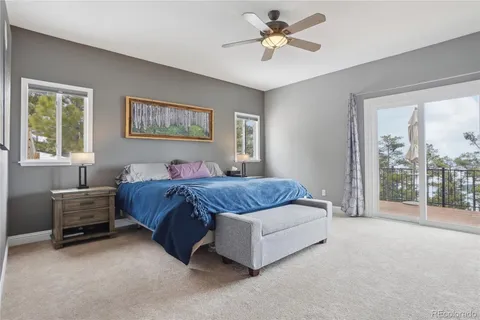 a spacious bedroom with a large bed and a chandelier
