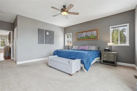 a spacious bedroom with a bed and a chandelier