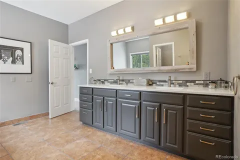 a bathroom with a sink vanity and a mirror