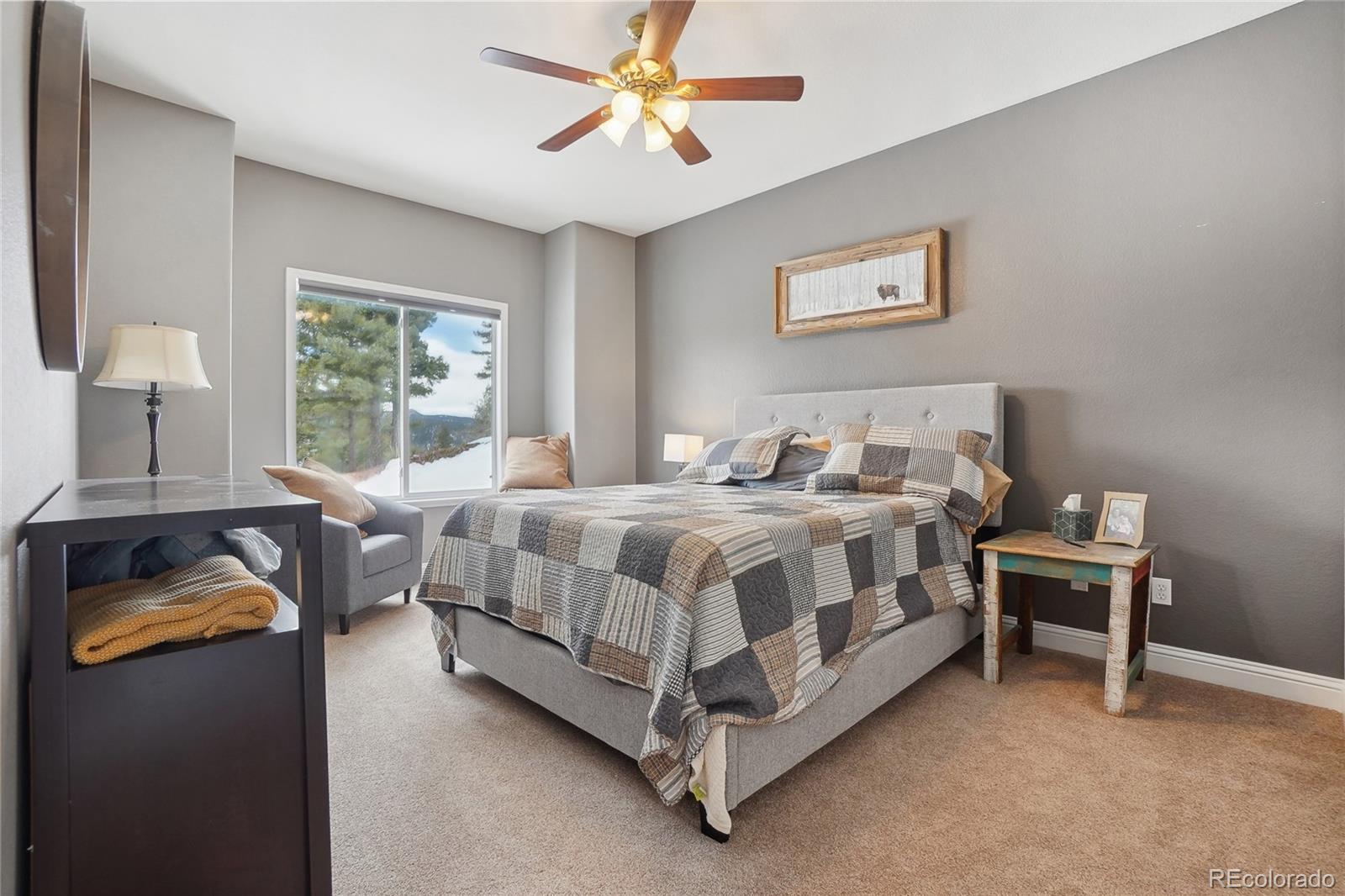 13084 Deer Ridge Way Larkspur, CO 80118 - Photo 26 of 48 a bedroom with a bed and a window