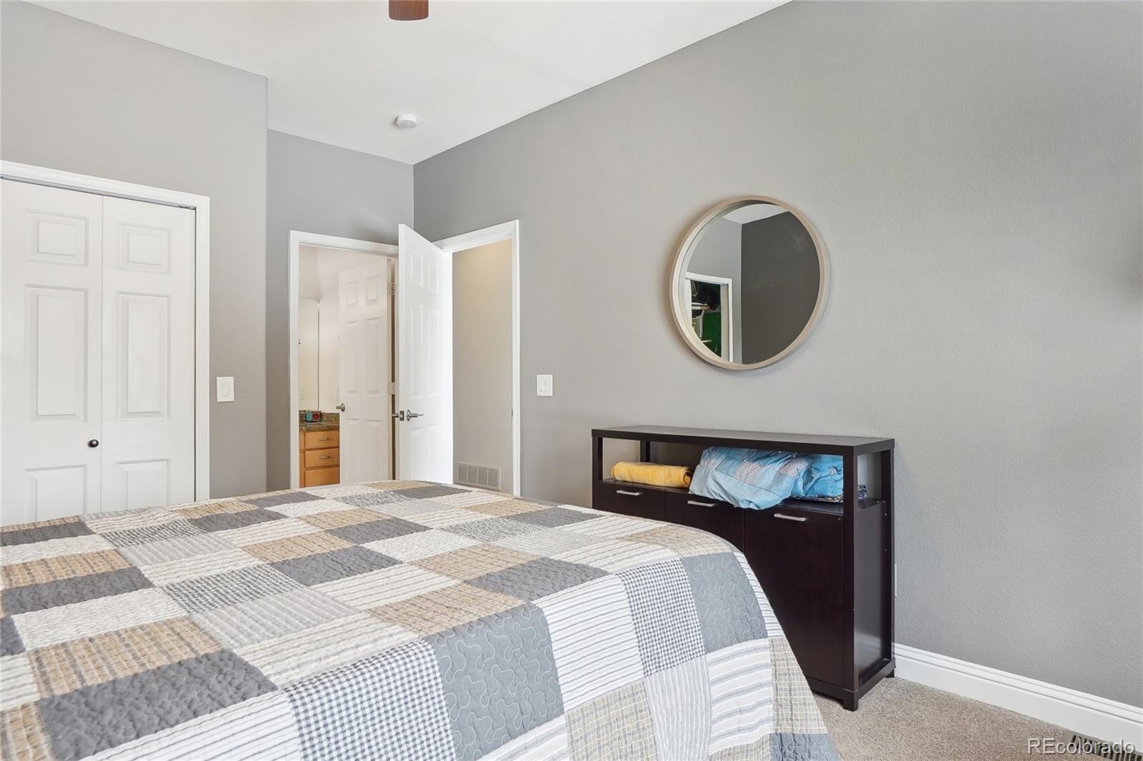 13084 Deer Ridge Way Larkspur, CO 80118 - Photo 27 of 48 a bedroom with a bed and a cabinets