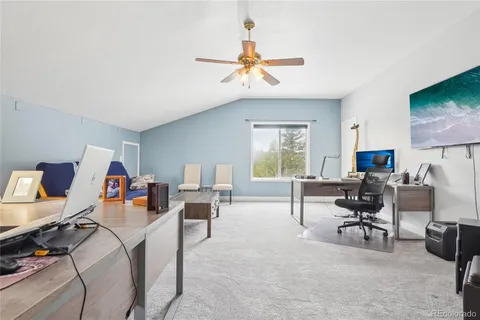 a view of a livingroom with workspace and a couch