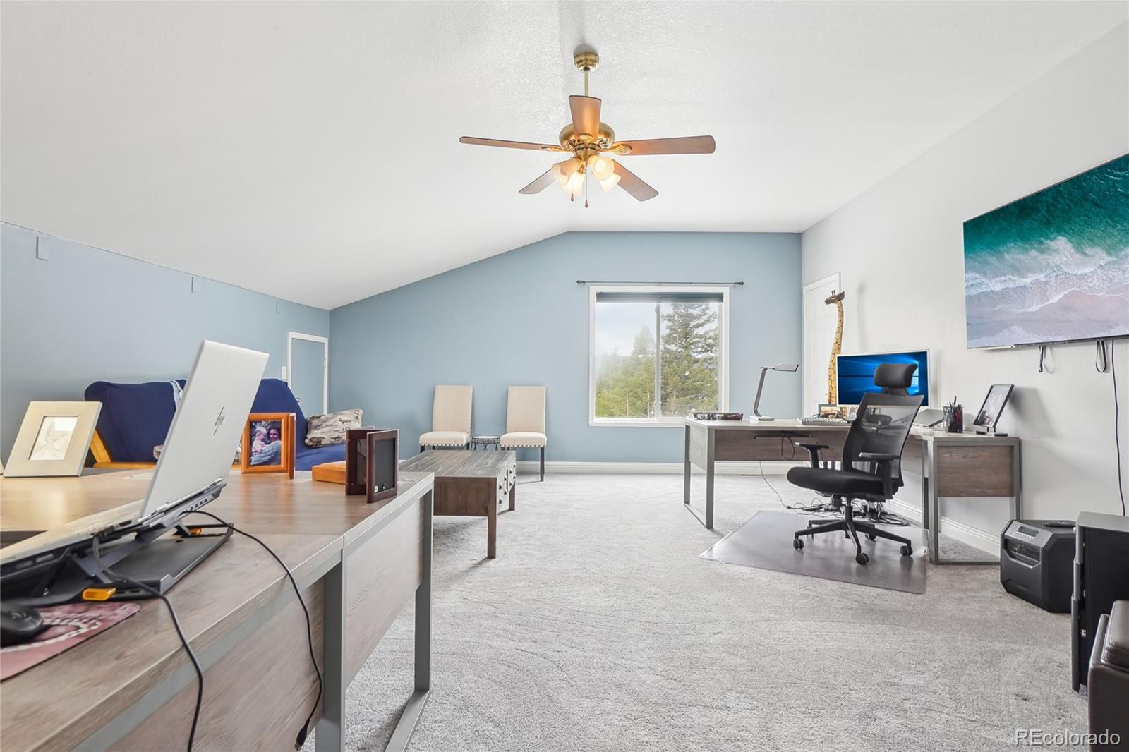 13084 Deer Ridge Way Larkspur, CO 80118 - Photo 29 of 48 a view of a livingroom with workspace and a couch