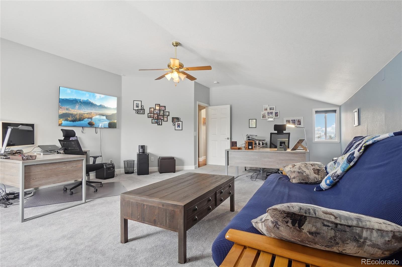 13084 Deer Ridge Way Larkspur, CO 80118 - Photo 30 of 48 a living room with furniture and wooden floor