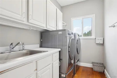 a bathroom with a sink a toilet and a window