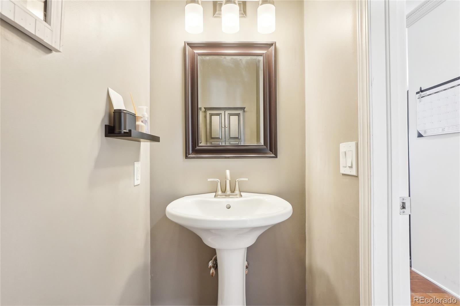 13084 Deer Ridge Way Larkspur, CO 80118 - Photo 32 of 48 a bathroom with a sink and a mirror