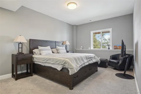 a bed room with a bed and a chair