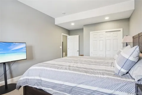a bedroom with a bed and a painting on the wall