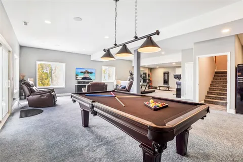 a living room with furniture a dining table and a chandelier