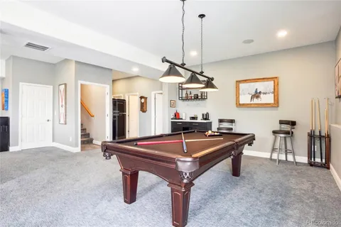 a room with furniture and pool table