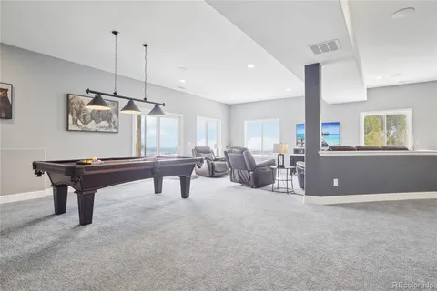 a living room with lots of furniture and a wooden floor