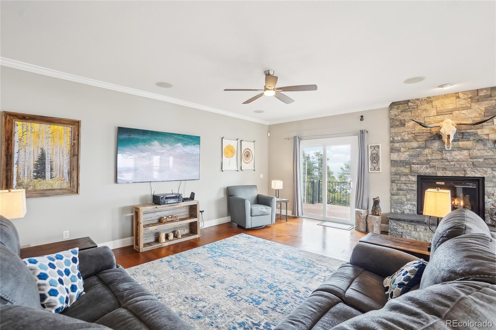 13084 Deer Ridge Way Larkspur, CO 80118 - Photo 7 of 48 a living room with furniture and a fireplace