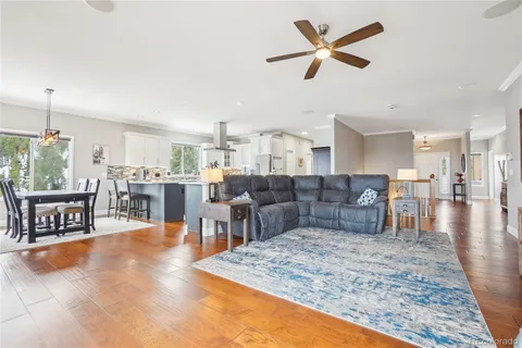 a living room with lots of furniture and kitchen view