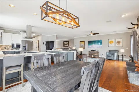 a large kitchen with a table and chairs in it