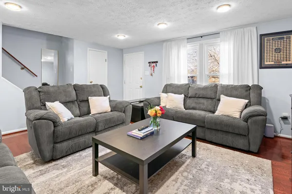a living room with furniture and a rug