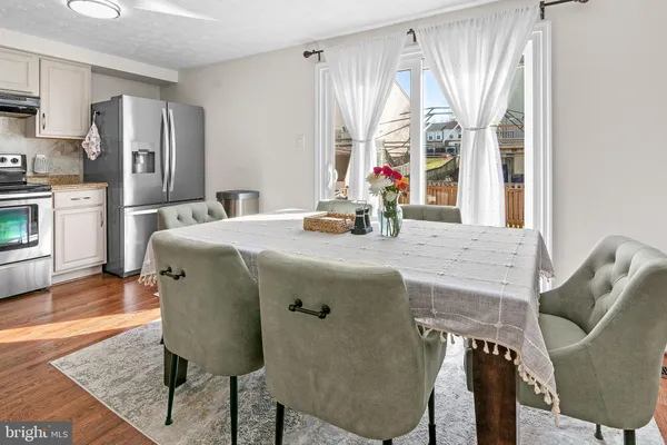 a dining table with chairs and window