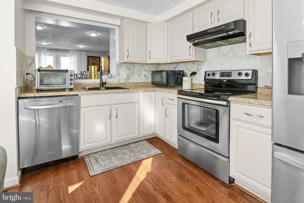 a kitchen with a stove and a sink