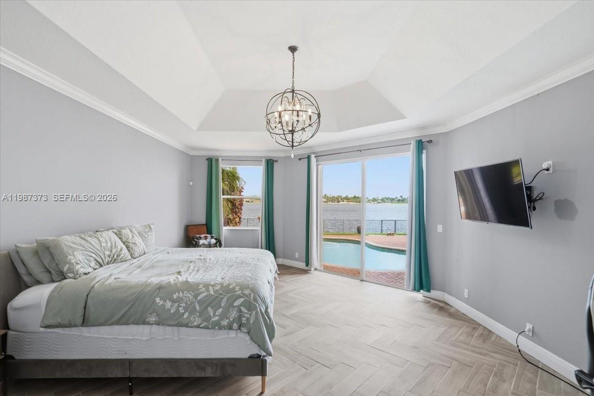 18631 Southwest 39th Street Miramar, FL 33029 - Photo 14 of 23 a bedroom with a bed and a television