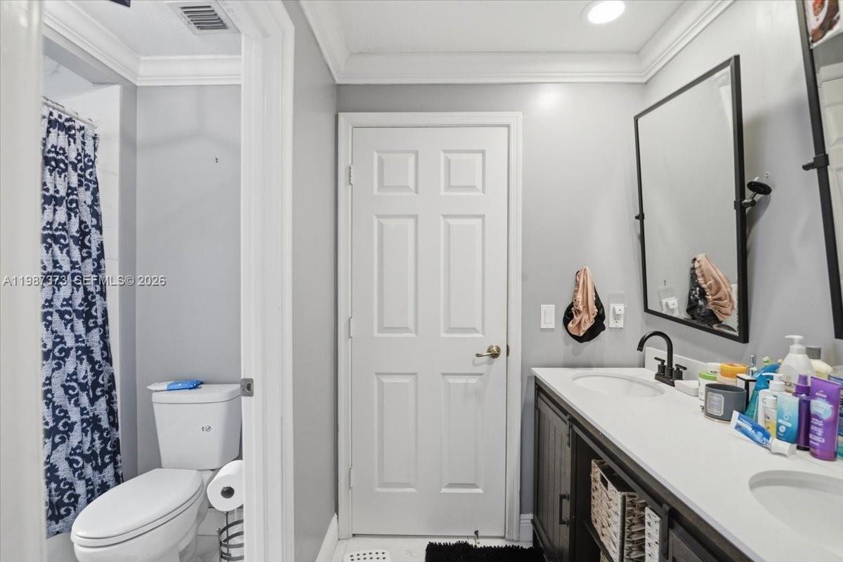 18631 Southwest 39th Street Miramar, FL 33029 - Photo 21 of 23 a bathroom with a sink a toilet and shower