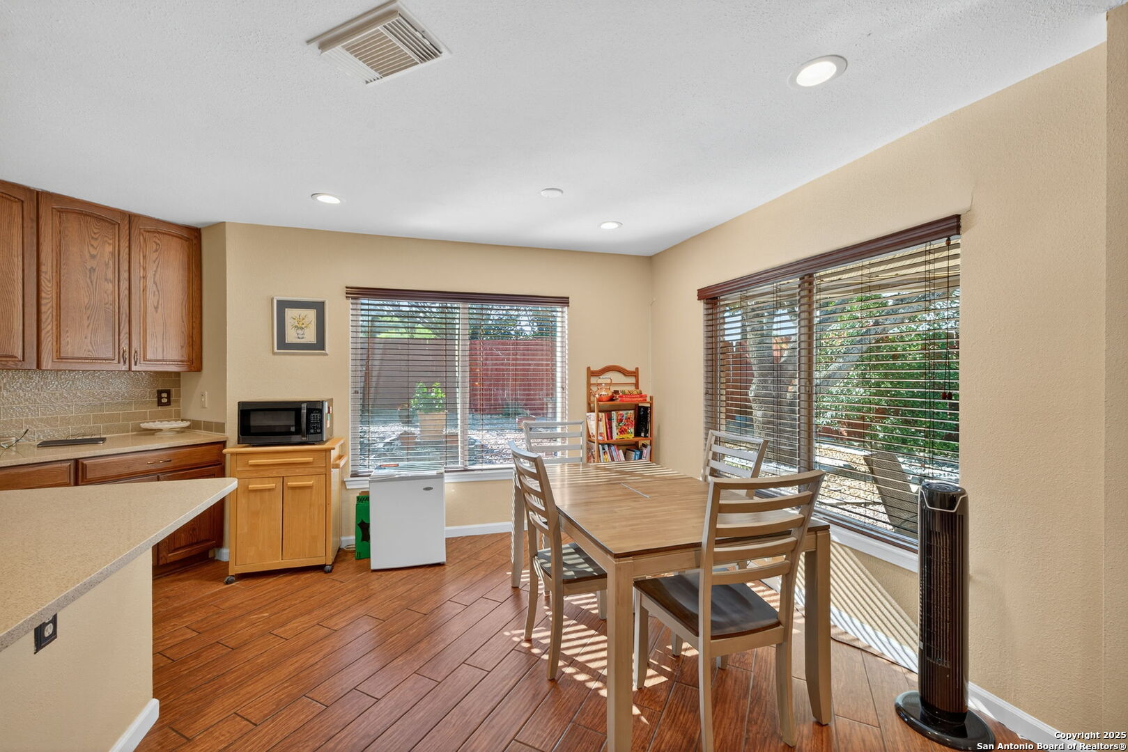 1902 Indian Meadows Drive San Antonio, TX 78230 - Photo 13 of 31 a kitchen with a table chairs refrigerator and cabinets