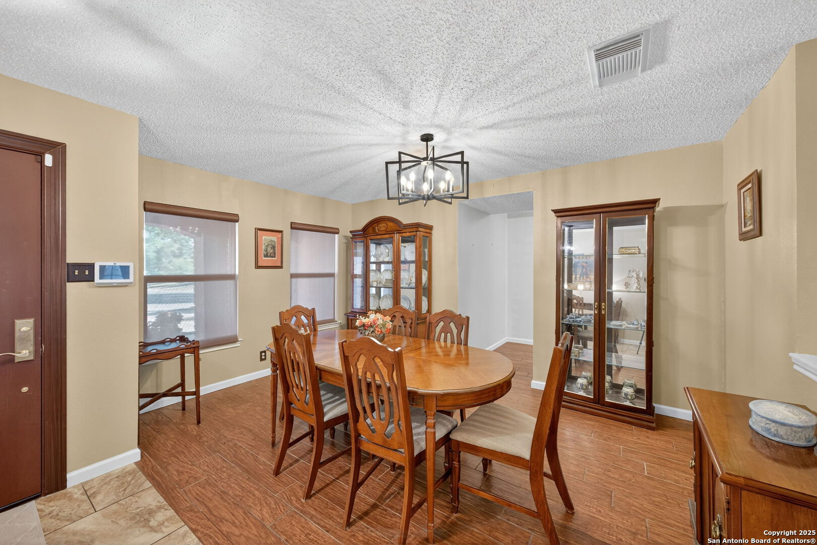 1902 Indian Meadows Drive San Antonio, TX 78230 - Photo 16 of 31 a view of a dining room with furniture and chandelier