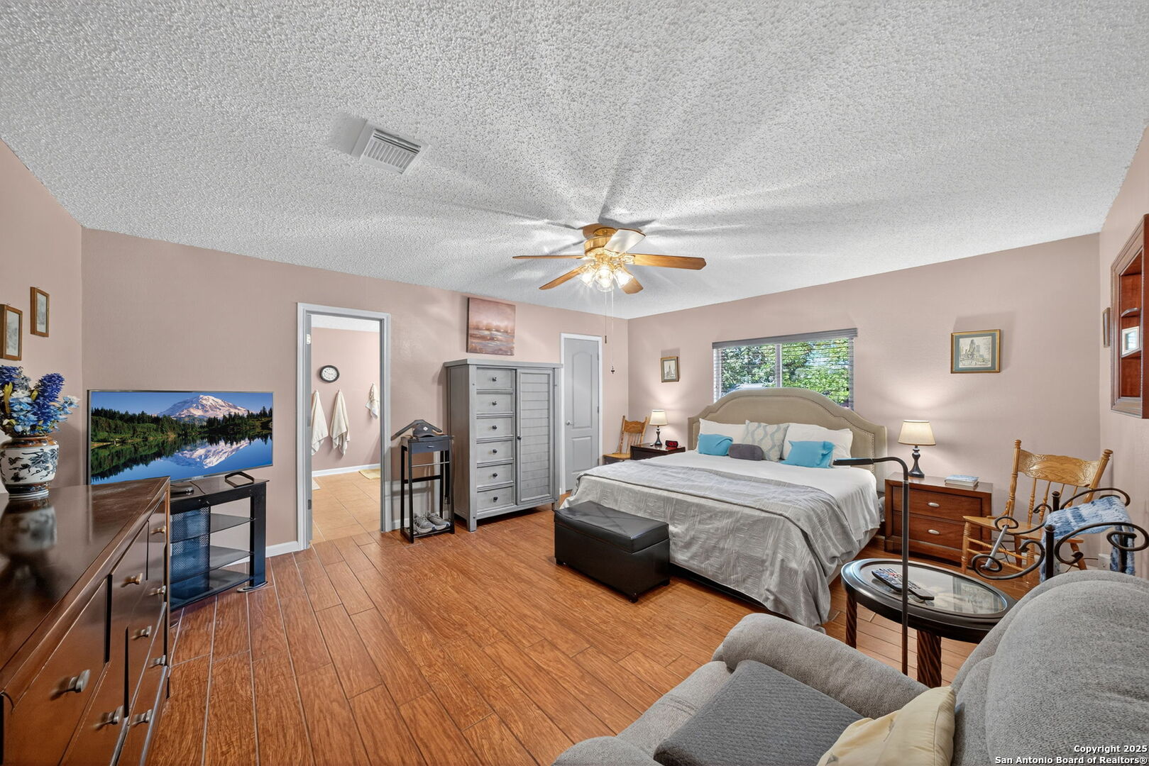 1902 Indian Meadows Drive San Antonio, TX 78230 - Photo 18 of 31 a spacious bedroom with a bed and a table