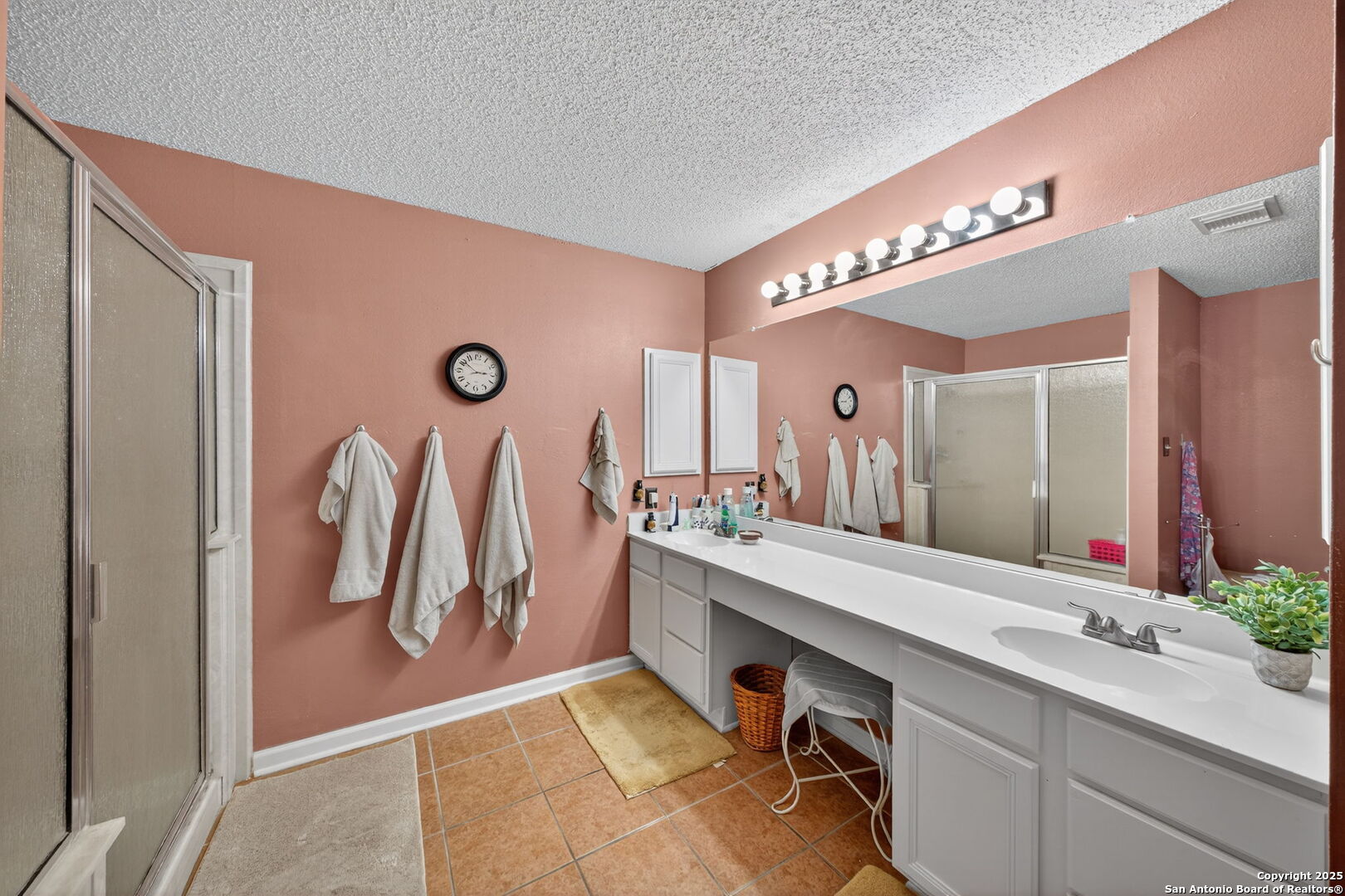 1902 Indian Meadows Drive San Antonio, TX 78230 - Photo 20 of 31 a bathroom with a double vanity sink a mirror and a shower