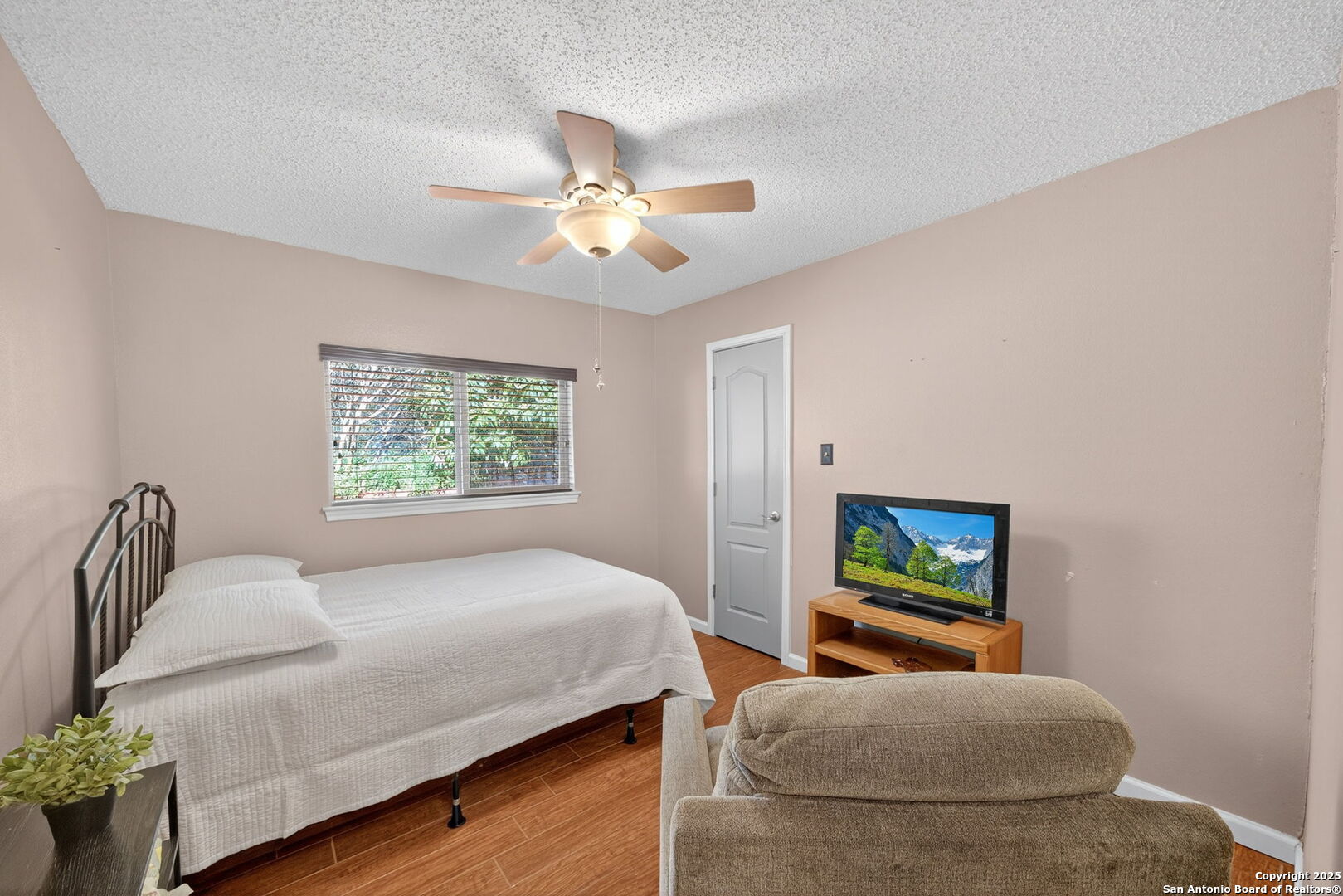 1902 Indian Meadows Drive San Antonio, TX 78230 - Photo 23 of 31 a bedroom with bed and a couch