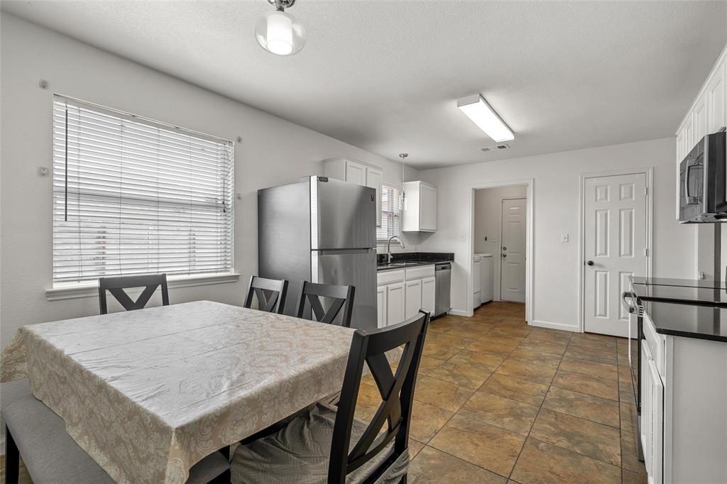 4209 Rance Lane Waco, TX 76708 - Photo 5 of 26 a kitchen with stainless steel appliances kitchen island granite countertop a refrigerator a stove a sink dishwasher with a dining table and chairs