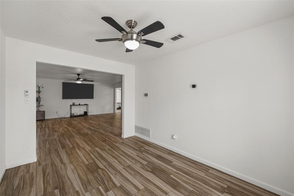 4209 Rance Lane Waco, TX 76708 - Photo 6 of 26 a view of a hallway with wooden floor and a ceiling fan