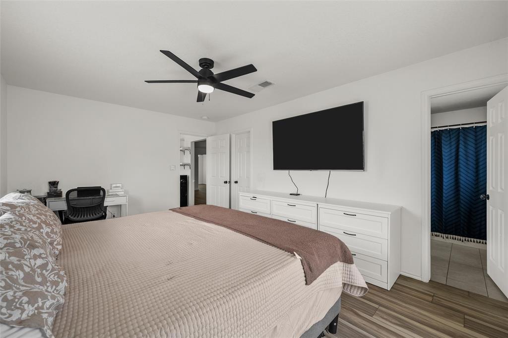 4209 Rance Lane Waco, TX 76708 - Photo 9 of 26 a bedroom with a bed and a flat screen tv