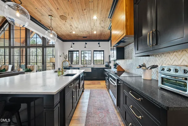 a kitchen with counter top space a sink and stainless steel appliances