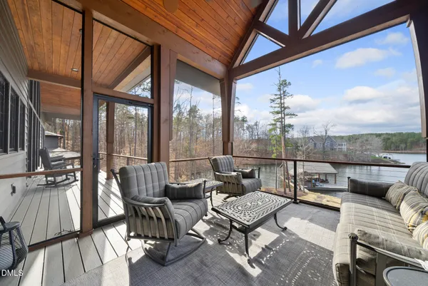 a view of a dining room with furniture a chandelier and wooden floor