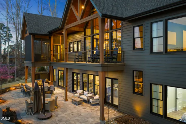 a view of a house with pool and chairs