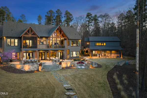 a view of a house with pool and sitting area