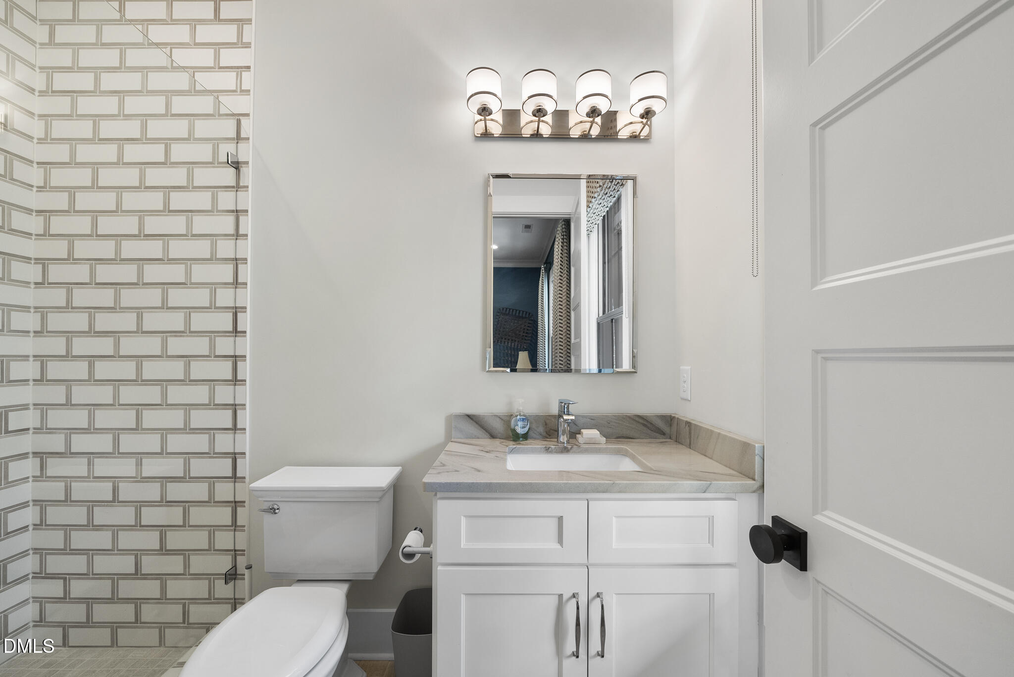 935 Estate Road Semora, NC 27343 - Photo 34 of 75 a bathroom with a toilet sink and mirror