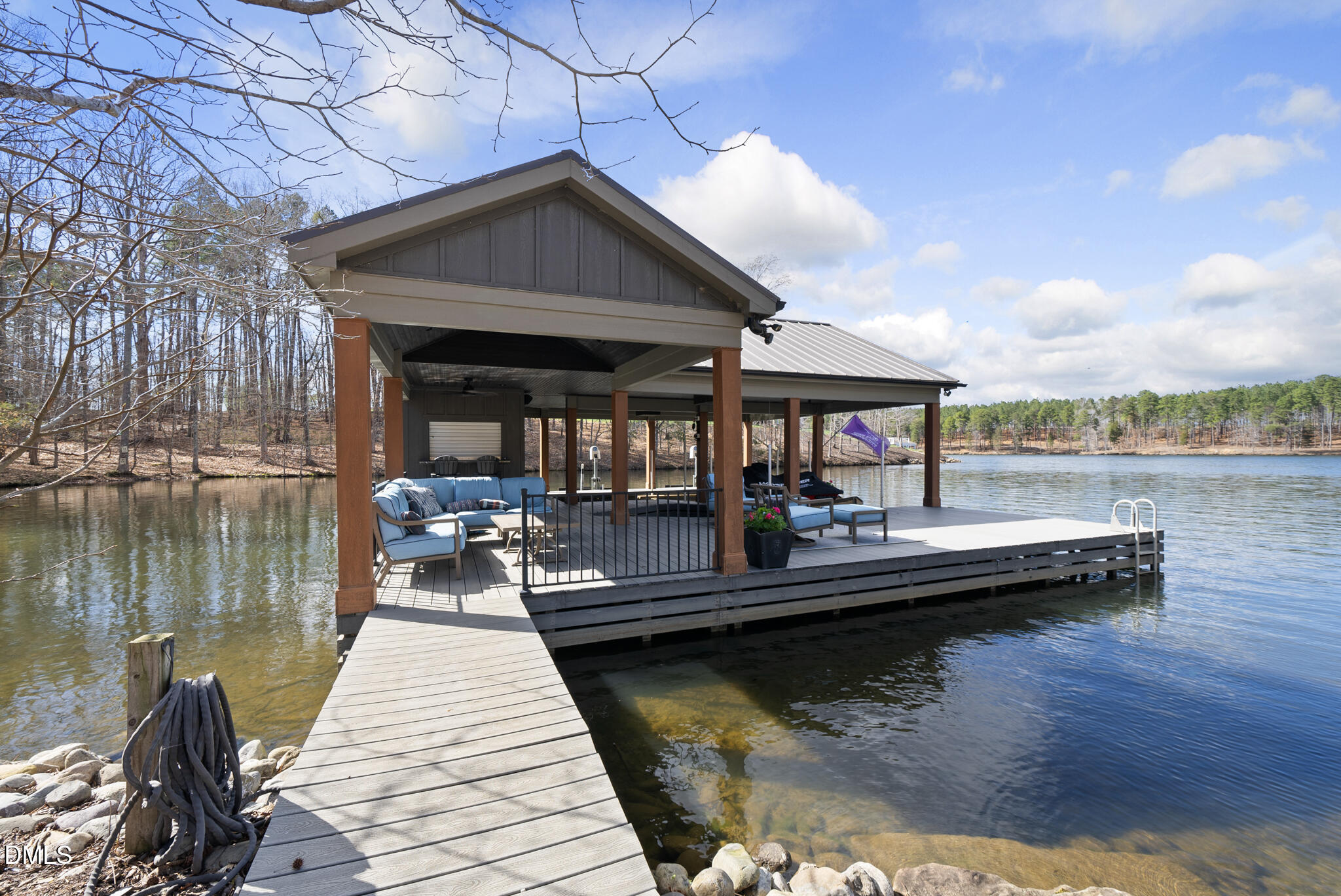 935 Estate Road Semora, NC 27343 - Photo 61 of 75 a view of a lake with couches chairs and wooden floor